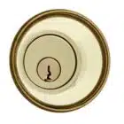 Circular brass deadbolt lock cylinder with a centered keyhole
