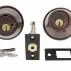 Carbine double cylinder deadbolt set in antique bronze finish with latch, strike plate, and two keys
