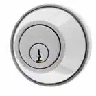 Circular chrome lock cylinder with CARBINE engraved above the keyhole