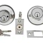 Carbine deadbolt lock set with two cylinders, latch mechanism, strike plate, and keys in a polished chrome finish