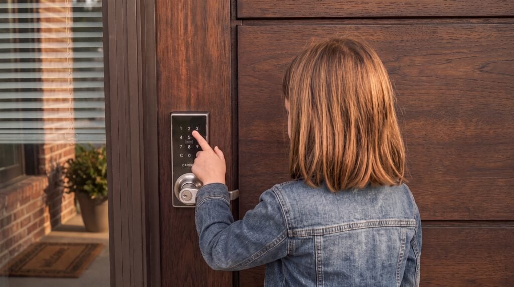 Child entering home using keyless door locks keypad